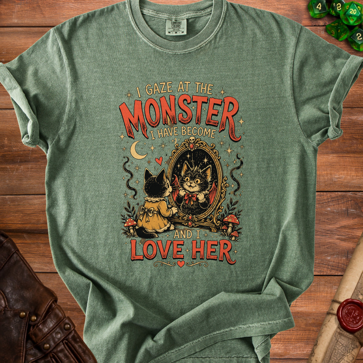 Green t-shirt with a cat looking in a mirror and the text "I Gaze At The Monster I Have Become And I Love Her".