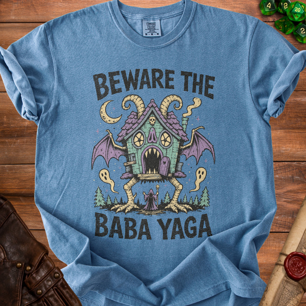 Blue t-shirt with "Beware The Baba Yaga" text and a Baba Yaga house illustration.
