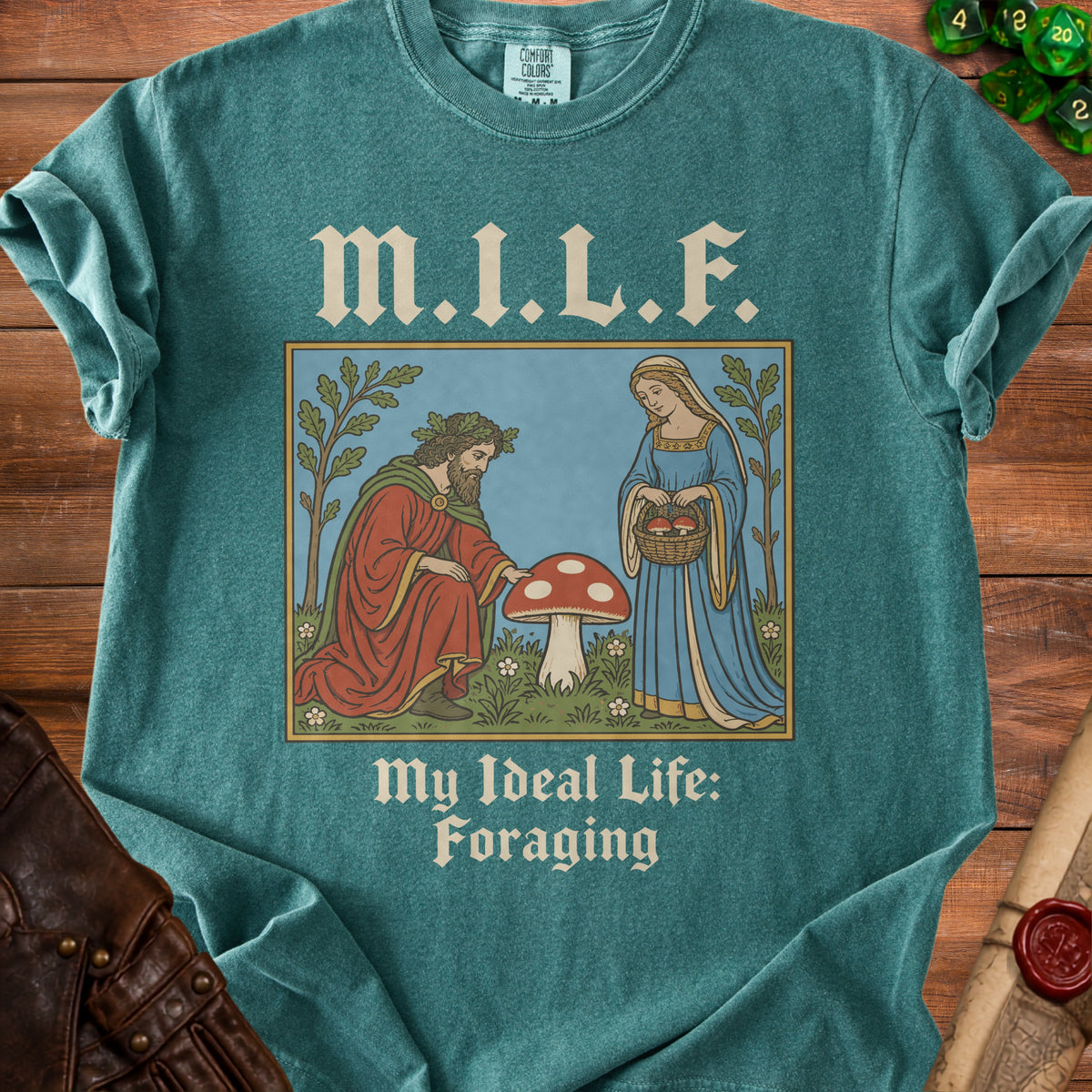 Teal t-shirt with text "M.I.L.F. My Ideal Life: Foraging" and a medieval illustration.