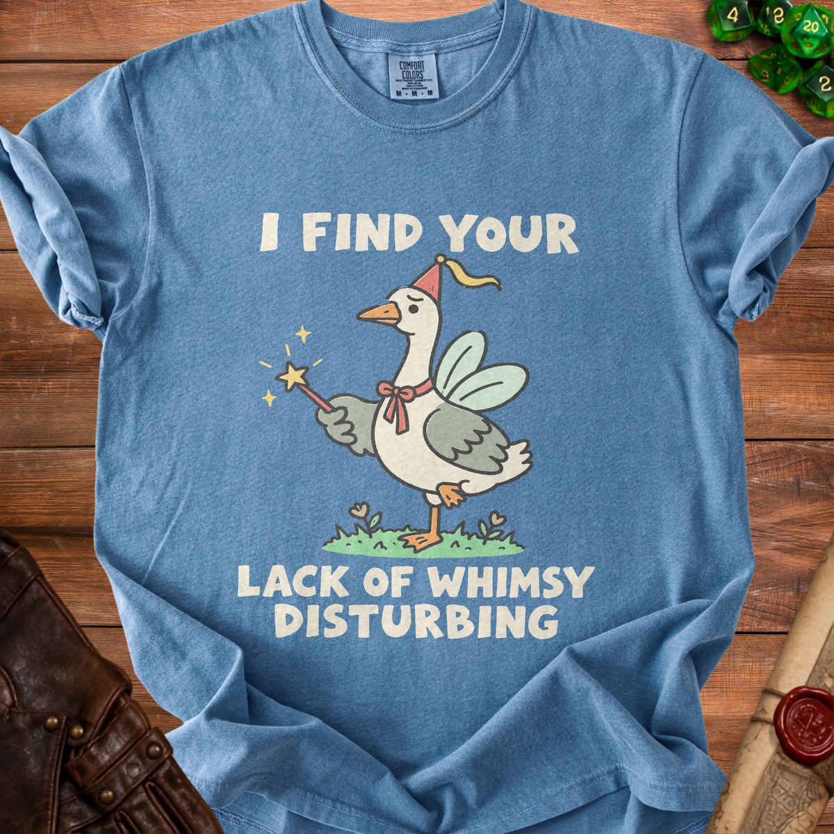 Blue t-shirt with goose wearing fairy wings and hat, holding wand with text "I find your lack of whimsy disturbing".