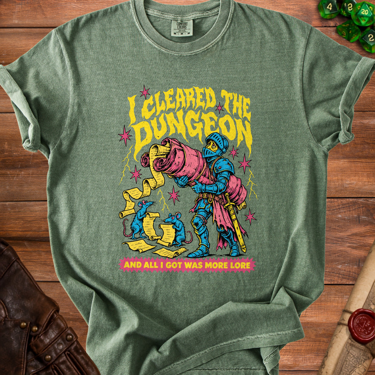 Green t-shirt with knight holding a scroll, blue mice, and text "I cleared the dungeon and all I got was more lore."