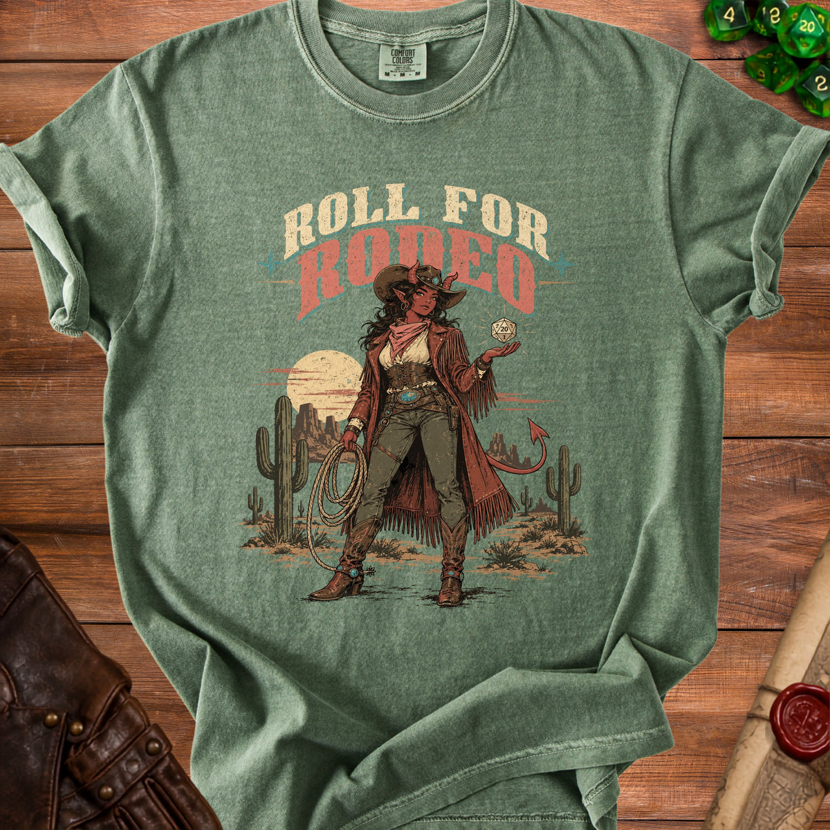 Green t-shirt with "Roll for Rodeo" text and a devilish cowgirl holding a D20 die.