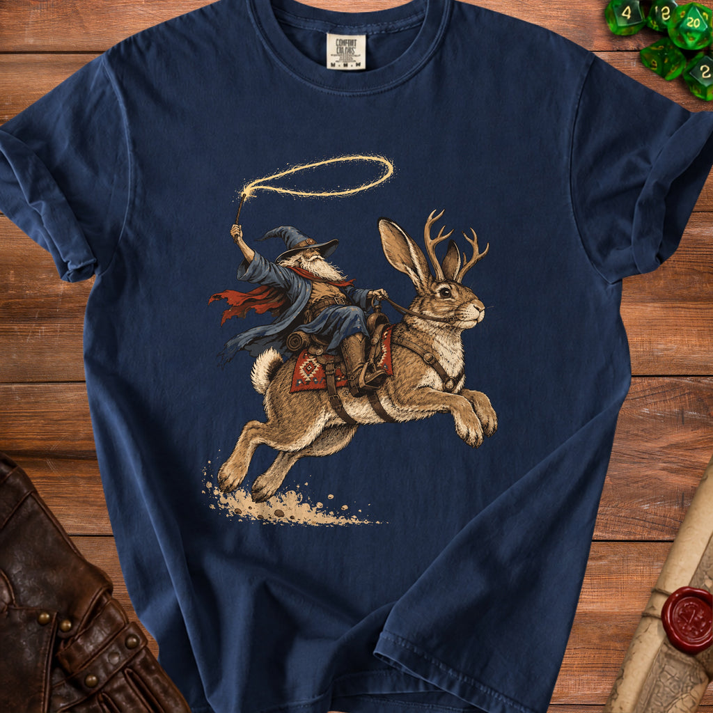 Wizard riding a jackalope with a lasso of light, on a navy blue shirt.