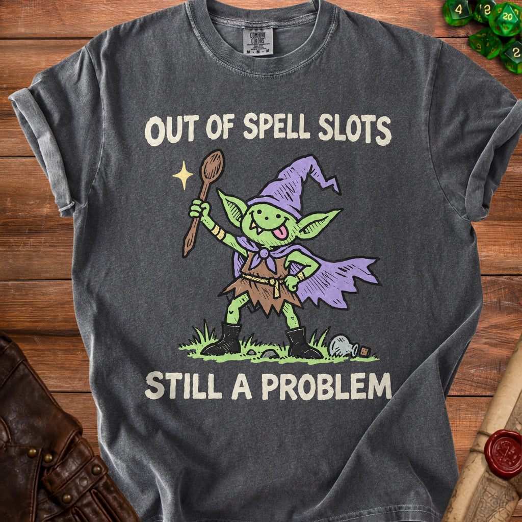 T-shirt with a green goblin wearing a wizard hat and holding a spoon, saying "Out of Spell Slots Still a Problem".