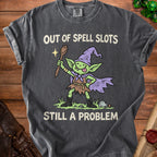 T-shirt with a green goblin wearing a wizard hat and holding a spoon, saying "Out of Spell Slots Still a Problem".