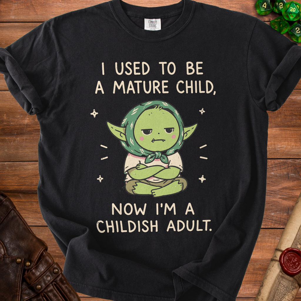 Black t-shirt with "I used to be a mature child, now I'm a childish adult" text and cartoon.