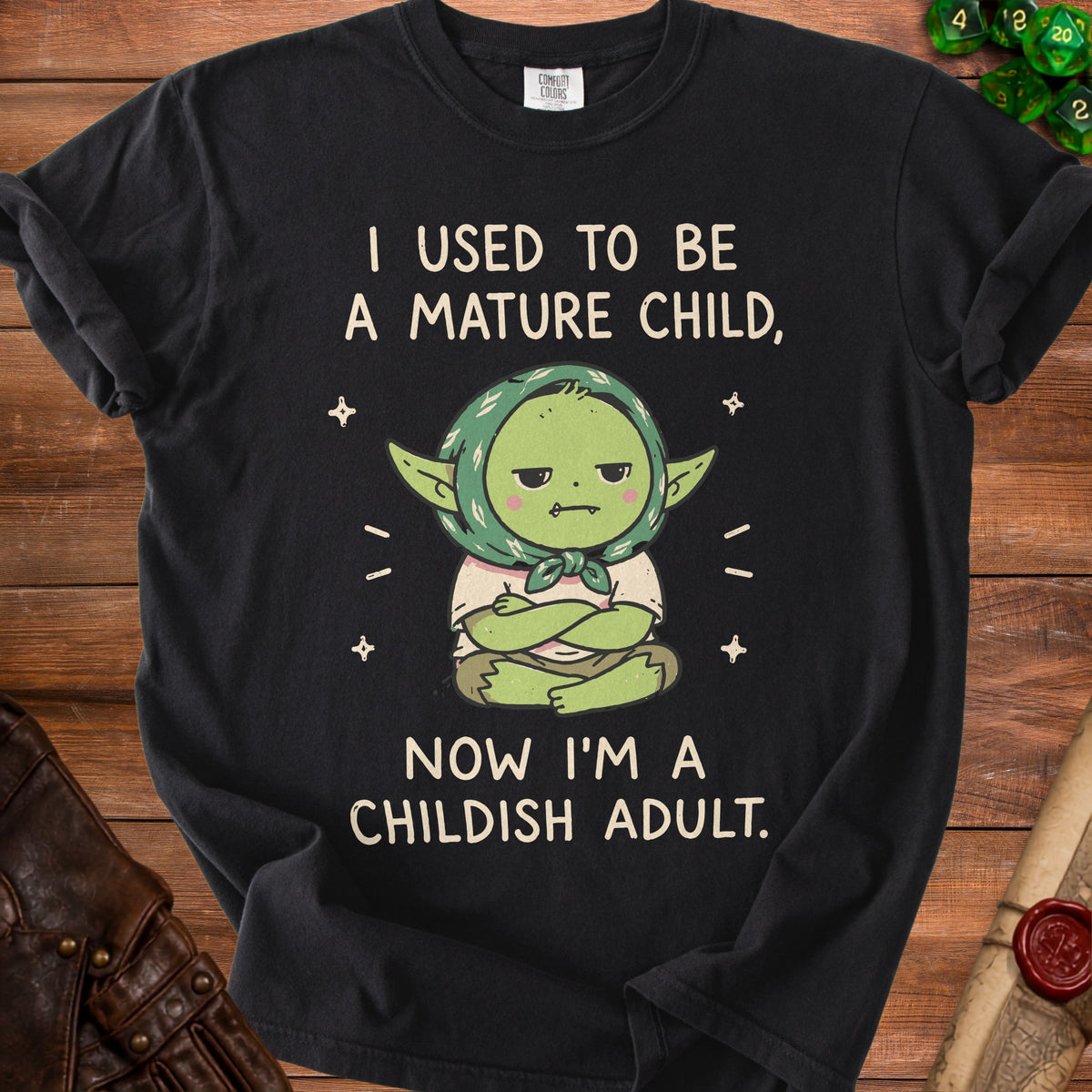 Black t-shirt with "I used to be a mature child, now I'm a childish adult" text and cartoon.