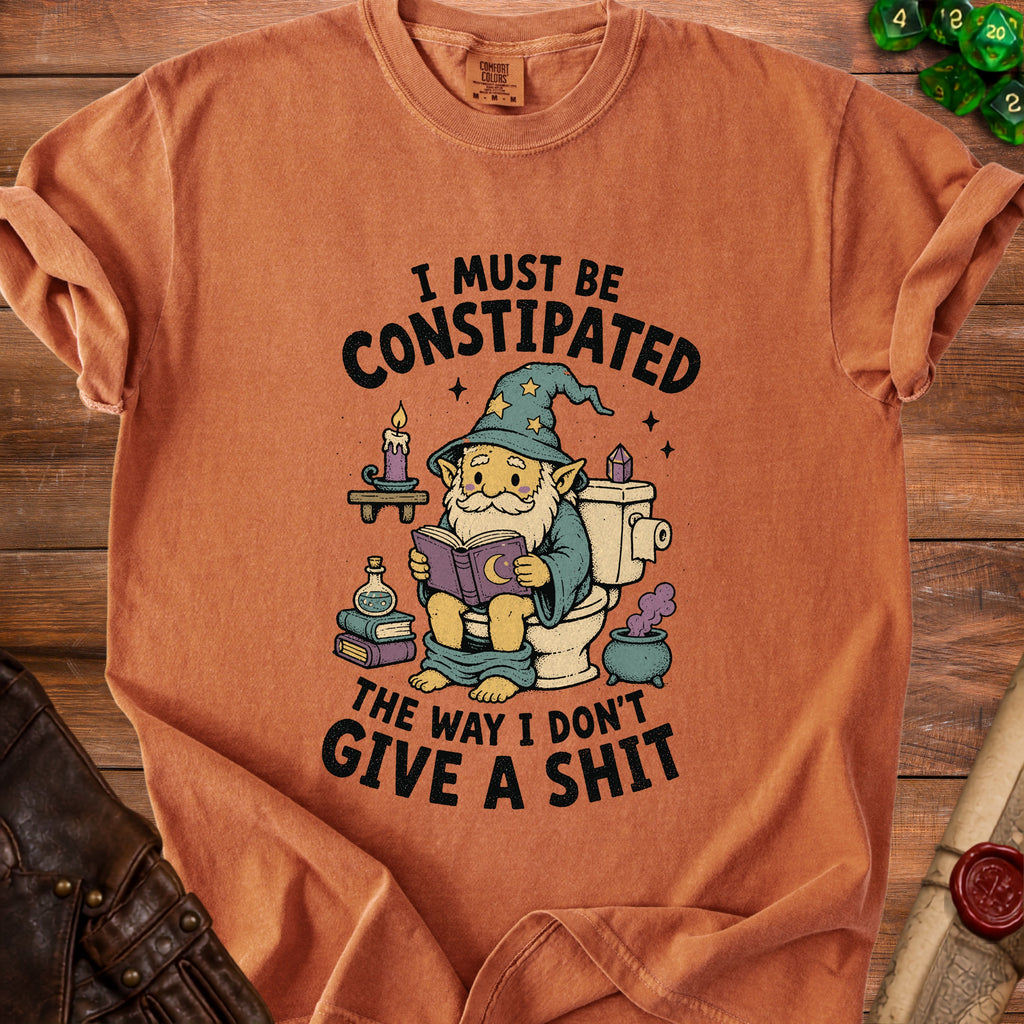T-shirt with gnome on toilet reading book and text "I must be constipated the way I don't give a shit".