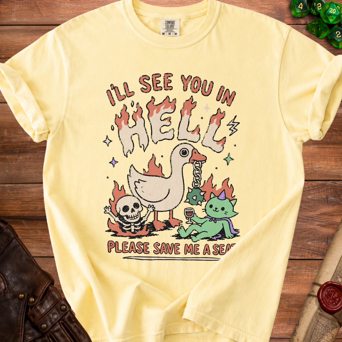 Yellow t-shirt with graphic art of a duck, skeleton, and cat in hell.