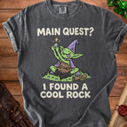 Dark gray t-shirt with "Main Quest? I Found a Cool Rock" and a goblin graphic.