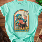 Mint green t-shirt with a goblin and angry ghost brewing potion; text: "PROBABLY HEALING".