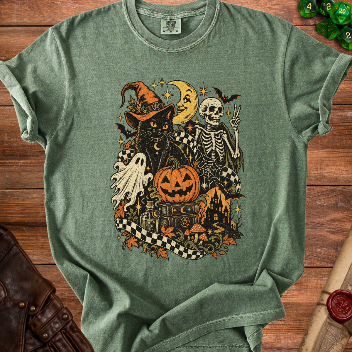 Green t-shirt with Halloween graphic featuring black cat, skeleton, pumpkin, and ghost.