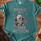Teal t-shirt with a screaming opossum and the words "PANIC IS A FREE ACTION".