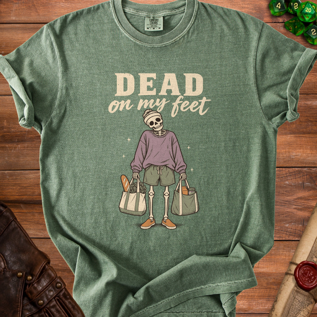 Green t-shirt with skeleton graphic and "DEAD on my feet" text.