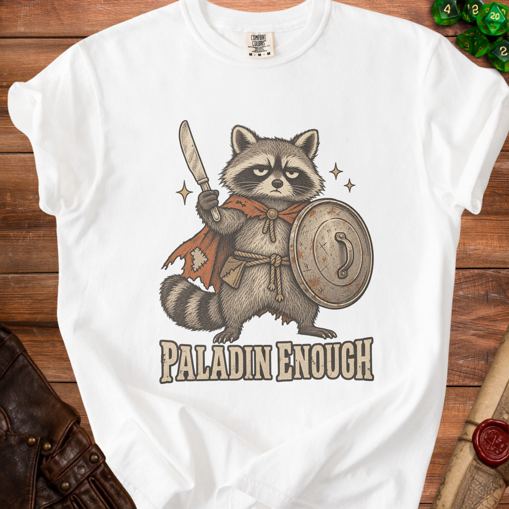 White t-shirt with illustration of a raccoon knight holding a sword and shield.