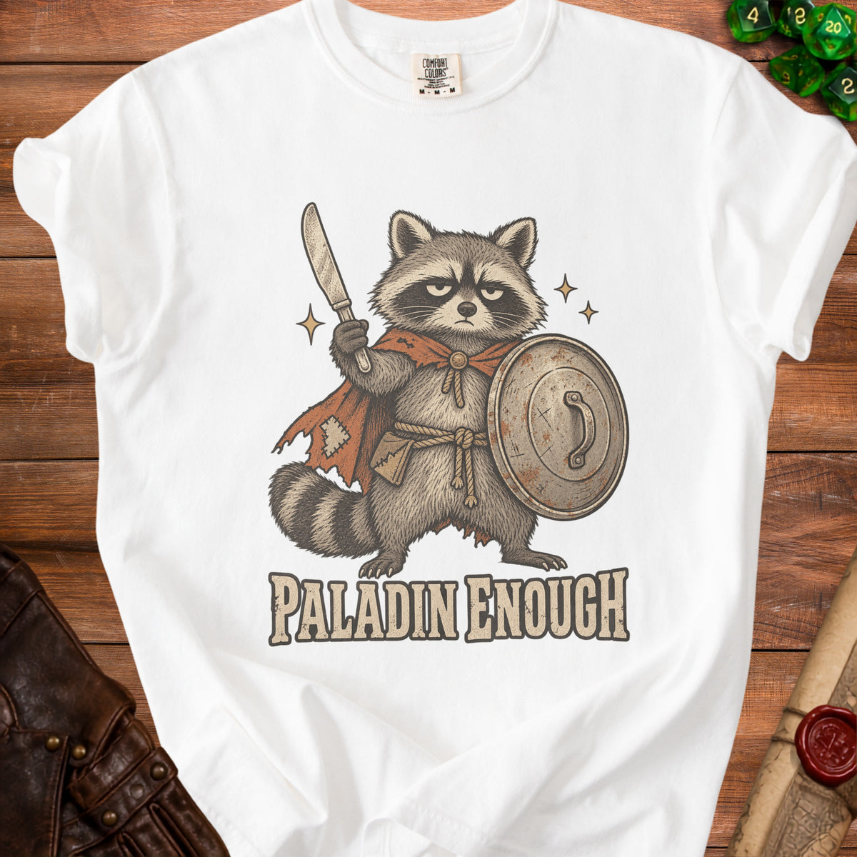 White t-shirt with illustration of a raccoon knight holding a sword and shield.