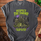 Dark t-shirt with "Respect The Swamp" and druids, a frog, and a skeleton.