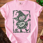 Pink t-shirt with a dark graphic of a goblin playing a lute, wearing a pointy hat.