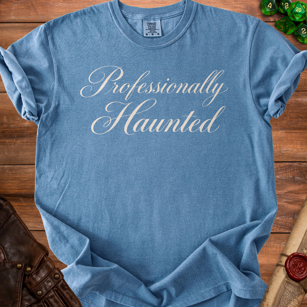 Blue t-shirt with "Professionally Haunted" in cursive text.