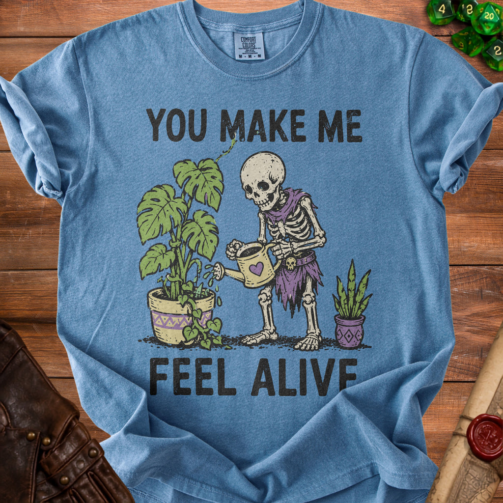 Skeleton watering plants with text "YOU MAKE ME FEEL ALIVE".