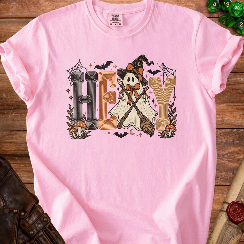 Pink t-shirt with a ghost wearing a witch hat and holding brooms, text "HEY".