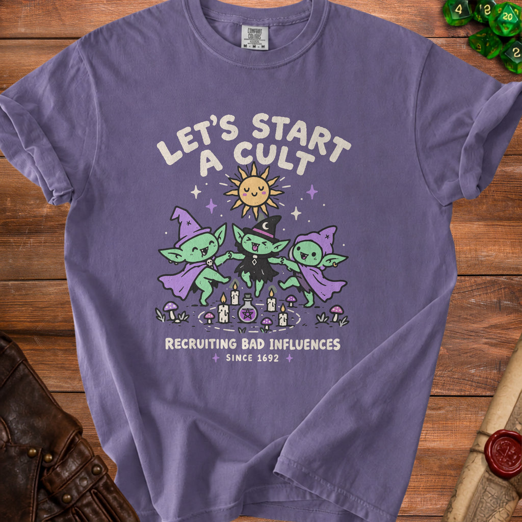 Purple t-shirt with "Let's Start A Cult Recruiting Bad Influences Since 1692" text and cartoon goblins.