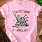 Pink t-shirt with a knight impaled by arrows and text "I THINK I NEED A LONG REST".