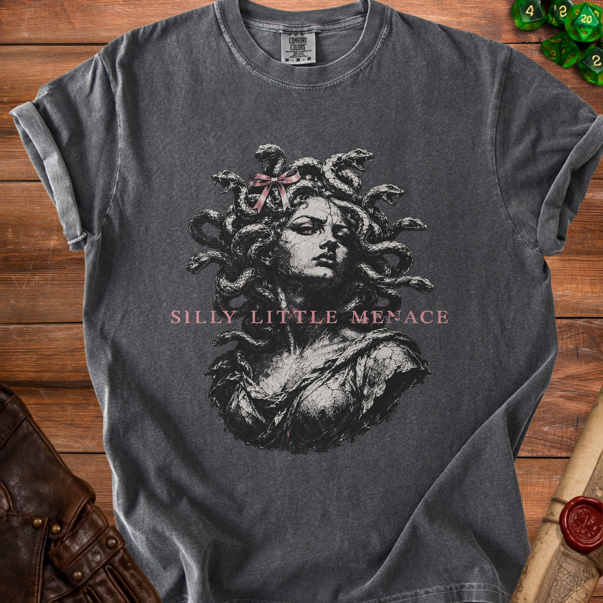 Dark grey t-shirt with Medusa graphic and pink text "Silly Little Menace".