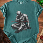 Green t-shirt with illustration of knight and text "Emotionally Medieval".