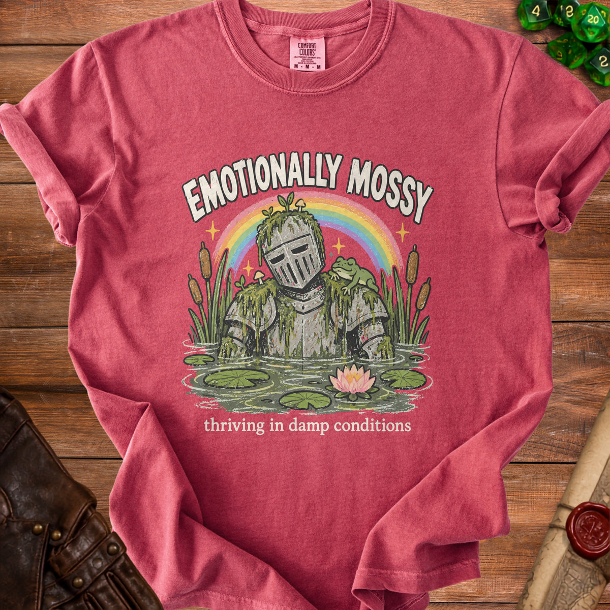 T-shirt with "Emotionally Mossy" graphic of knight in pond with frog.