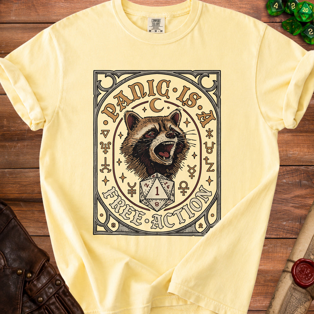 Yellow t-shirt with raccoon and dice graphic reading "Panic is Free Action".