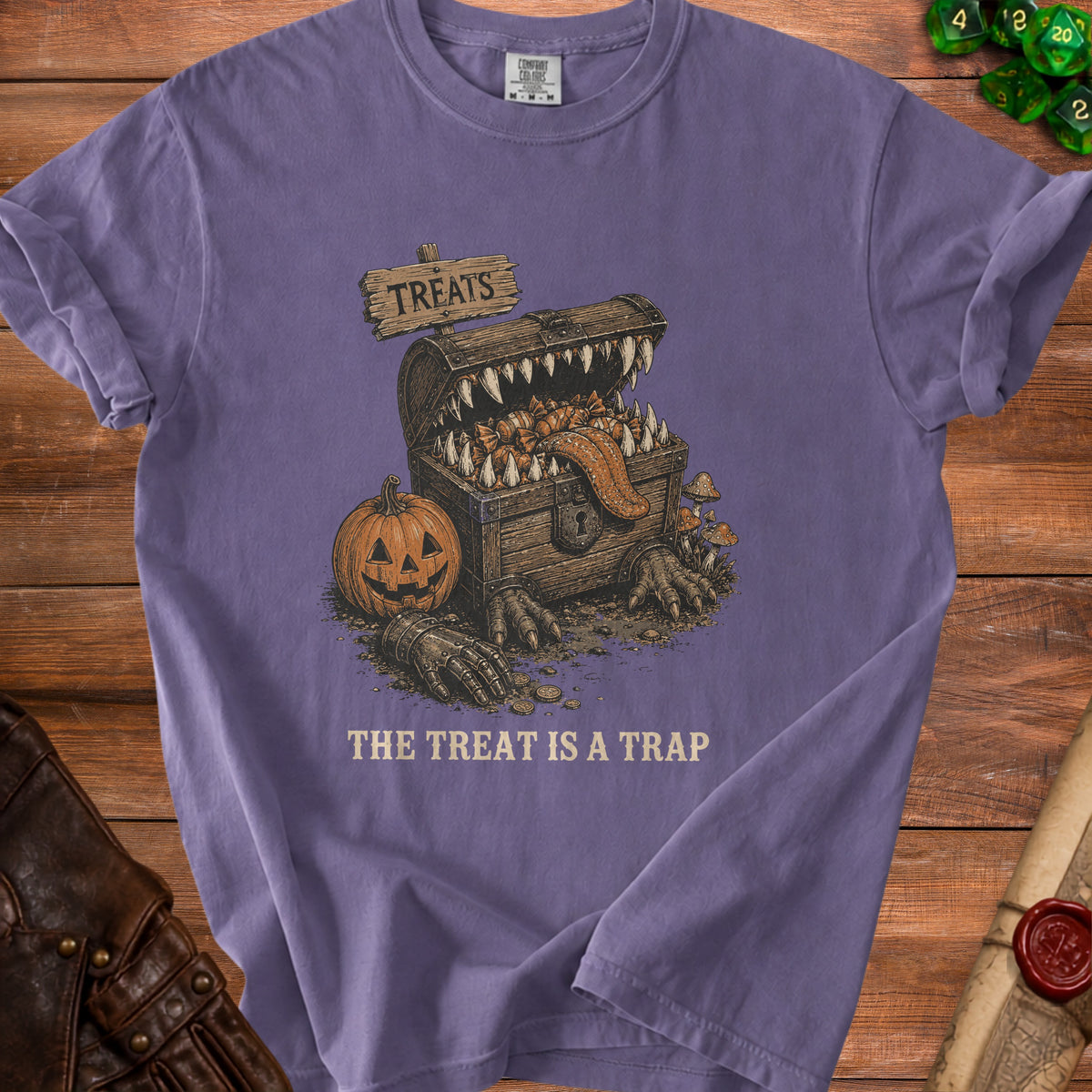 Monster chest with candy, pumpkin, and text "THE TREAT IS A TRAP".