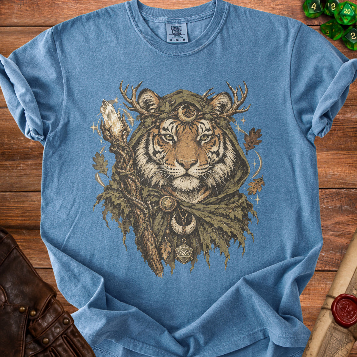 Blue t-shirt with print of a tiger wearing antlers, cloak, and holding a staff with crystal.