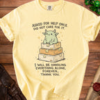 Yellow t-shirt with a cartoon creature sitting on stacked boxes and text.