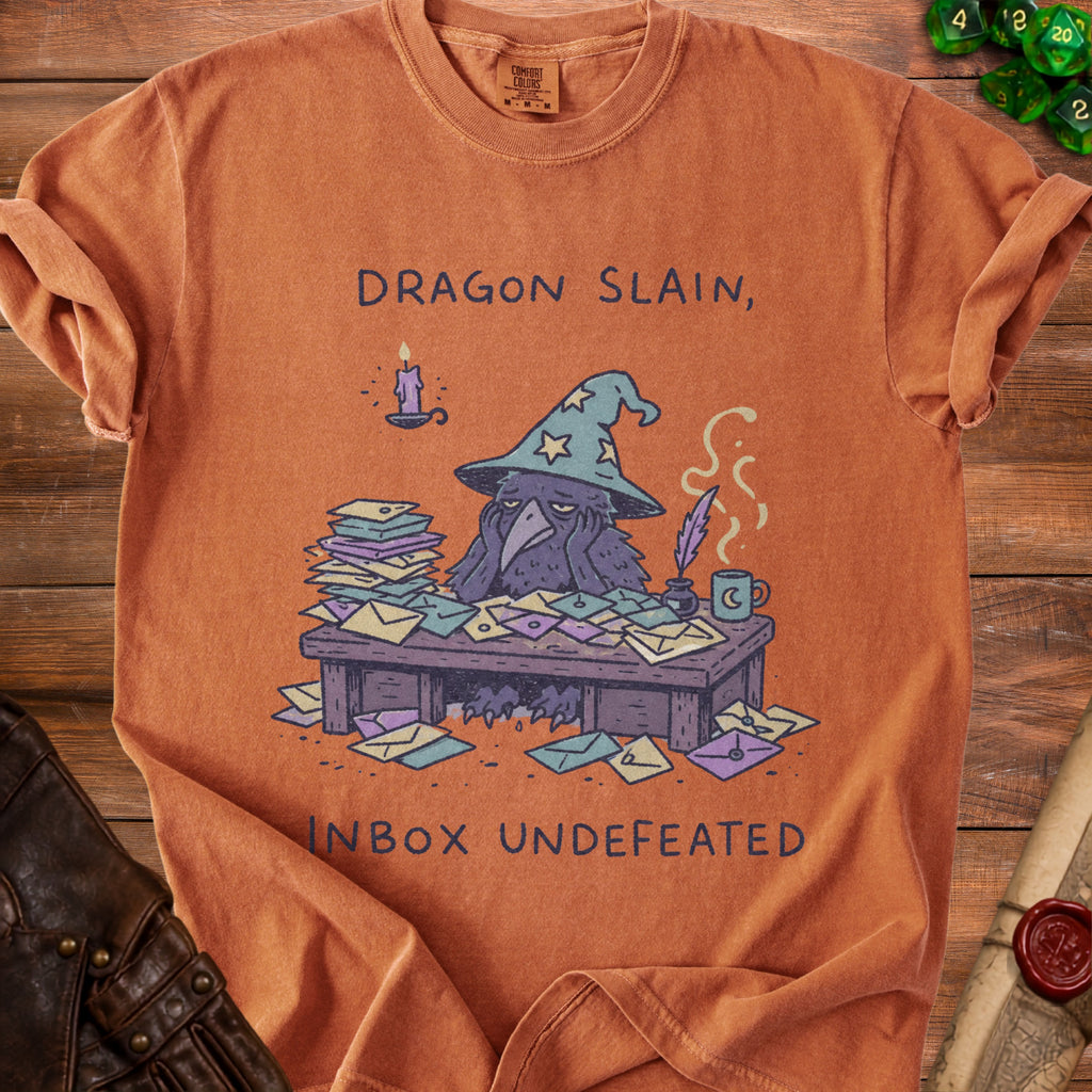 Orange t-shirt with a raven wearing a wizard hat and text "Dragon Slain, Inbox Undefeated".