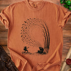 Goblin facing open treasure chest with bats flying out, on a burnt orange t-shirt.