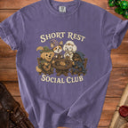 Four cartoon dogs in fantasy attire sit at a table with text "SHORT REST SOCIAL CLUB".