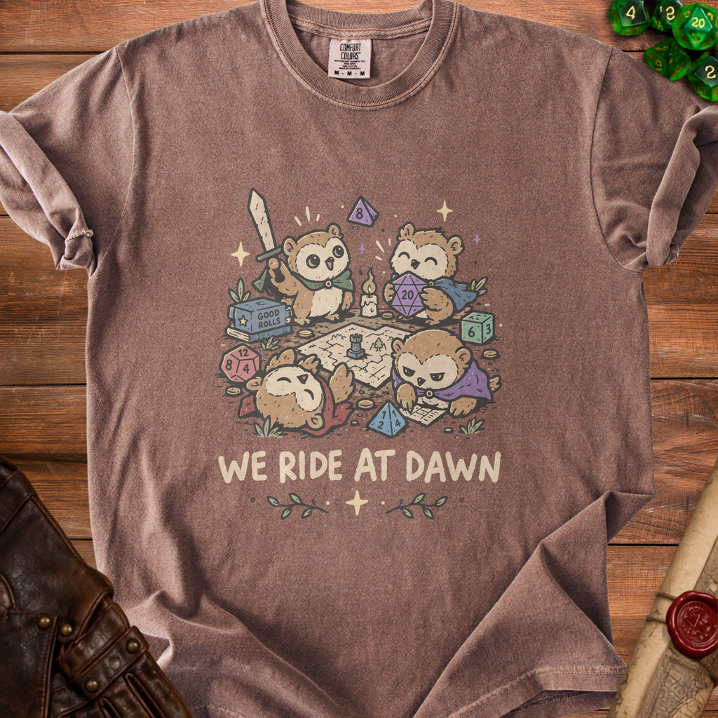 Brown t-shirt with "We Ride at Dawn" text and cartoon owls playing a tabletop game.