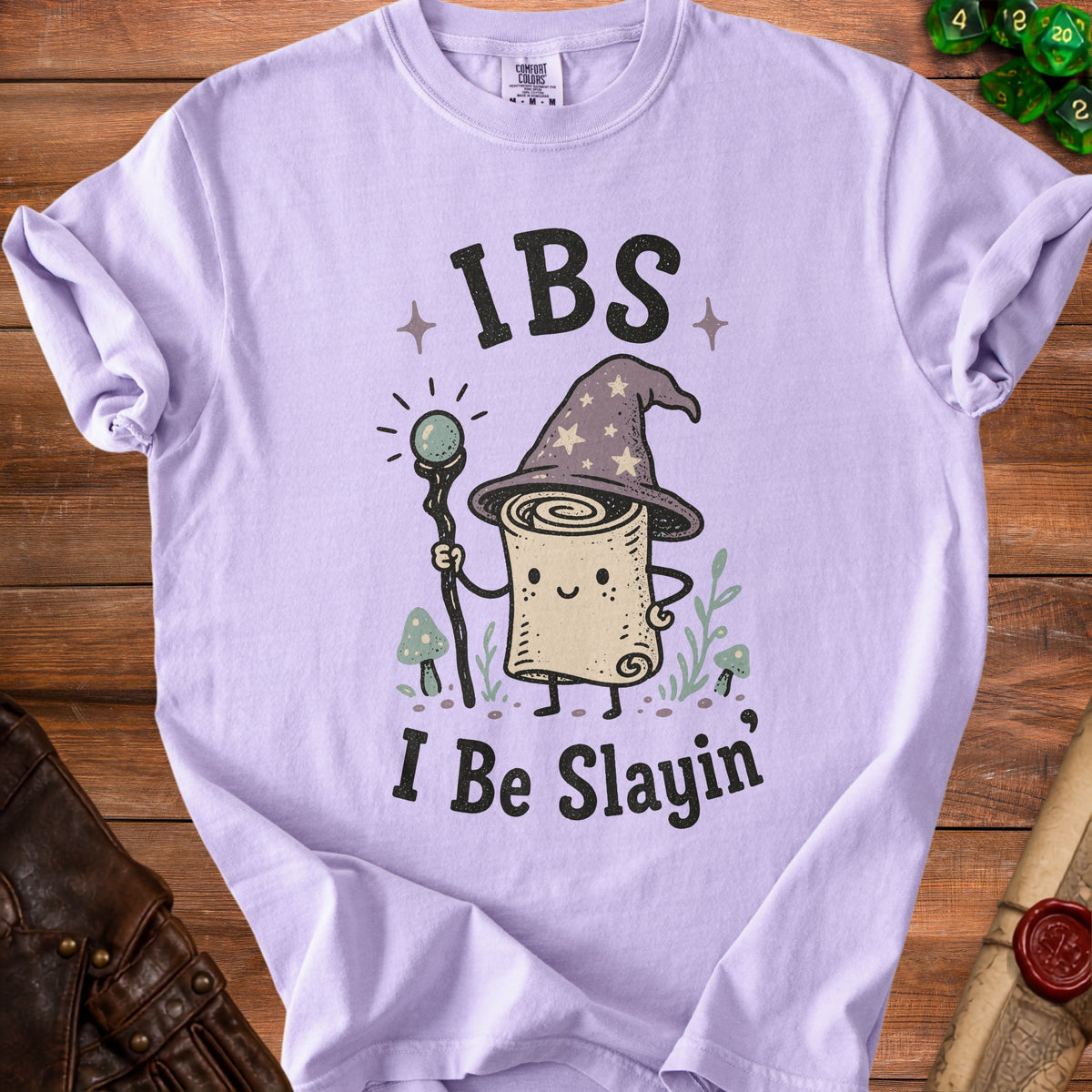 Purple t-shirt with cartoon wizard scroll saying "IBS I Be Slayin'".