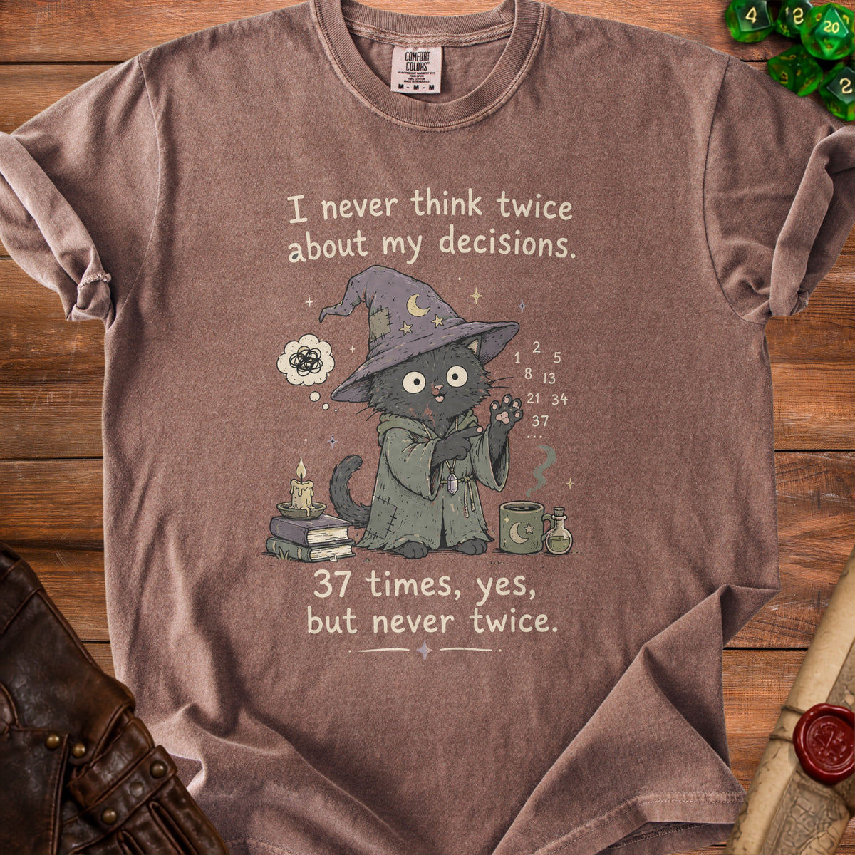 Brown t-shirt with wizard cat illustration and the text "I never think twice about my decisions. 37 times, yes, but never twice."