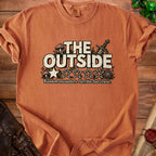Orange t-shirt with "THE OUTSIDE" text, sword, mushrooms, and stars.