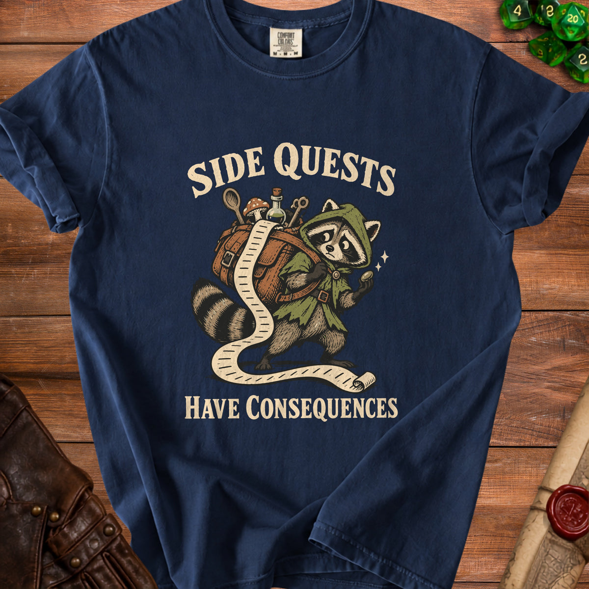 Navy t-shirt with raccoon carrying a bag and a quest scroll, reads "Side Quests Have Consequences."