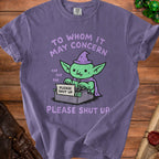 Purple t-shirt with green goblin typing "PLEASE SHUT UP" on a typewriter.