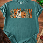 Teal Comfort Colors t-shirt with "SPOOKY" text featuring ghost, pumpkin, and floral Halloween graphics.