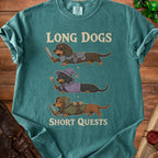 Teal t-shirt with cartoon dachshunds as a warrior, wizard, and archer. Text: "LONG DOGS SHORT QUESTS".