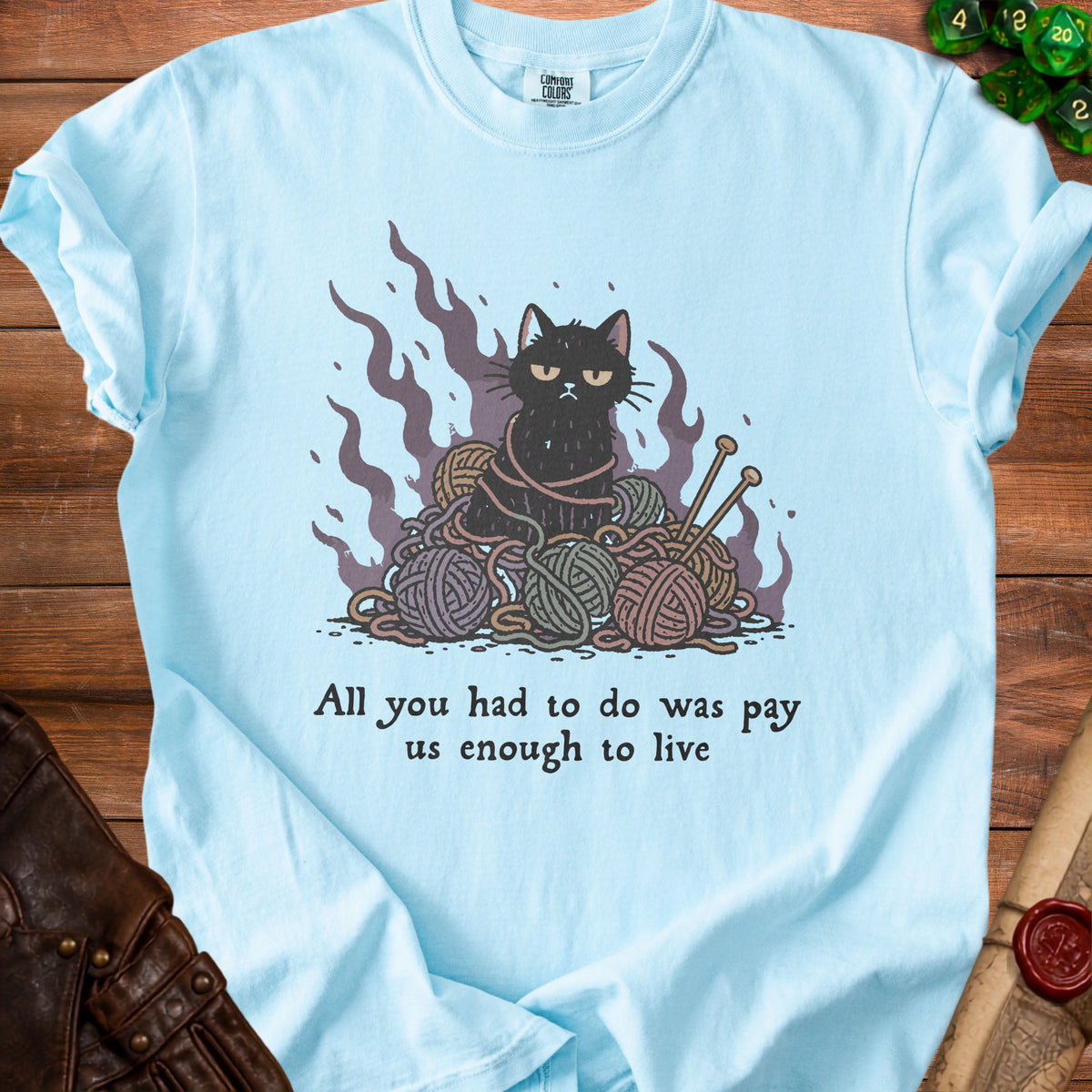Light blue t-shirt with a grumpy black cat tangled in yarn and knitting needles.
