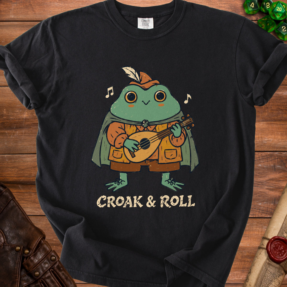Black t-shirt with a cartoon frog playing a lute and the text "CROAK & ROLL".