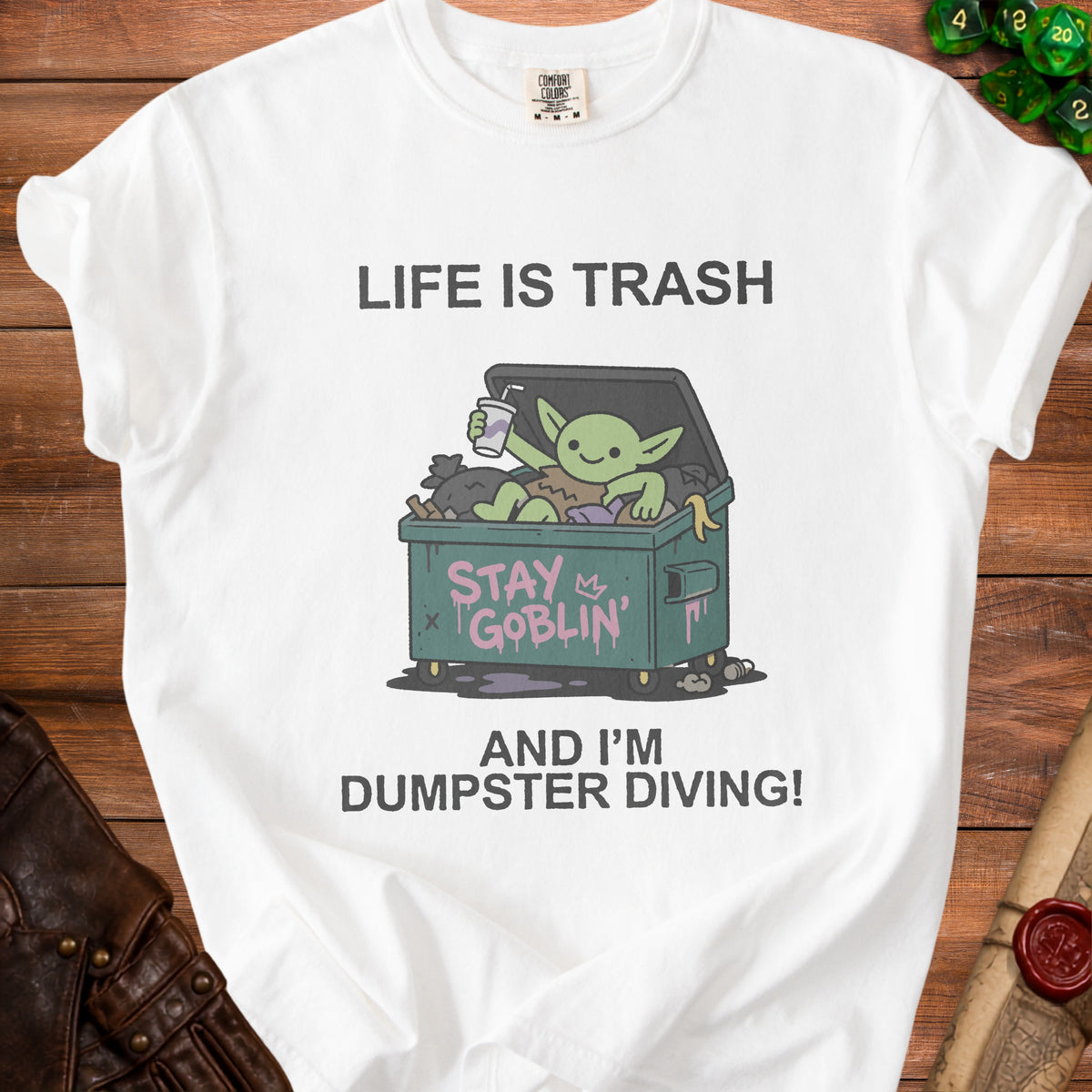 White t-shirt with "Life is Trash" and a goblin in a dumpster diving.