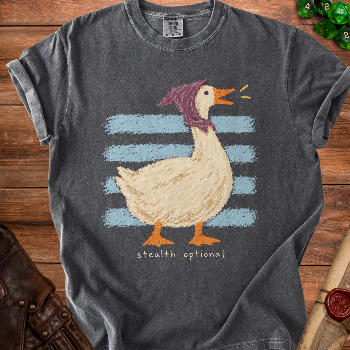 Dark grey t-shirt with graphic of a goose wearing a purple headscarf and the text "stealth optional".