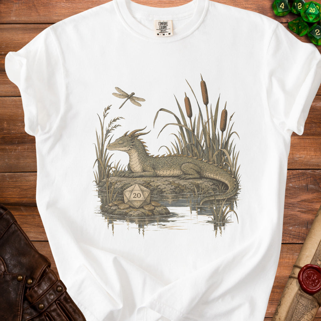 White t-shirt with a dragon, dragonfly, cattails, and a twenty-sided die graphic.
